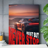 Motivational wall art with a black sports car at sunset and red “Never Stop” text