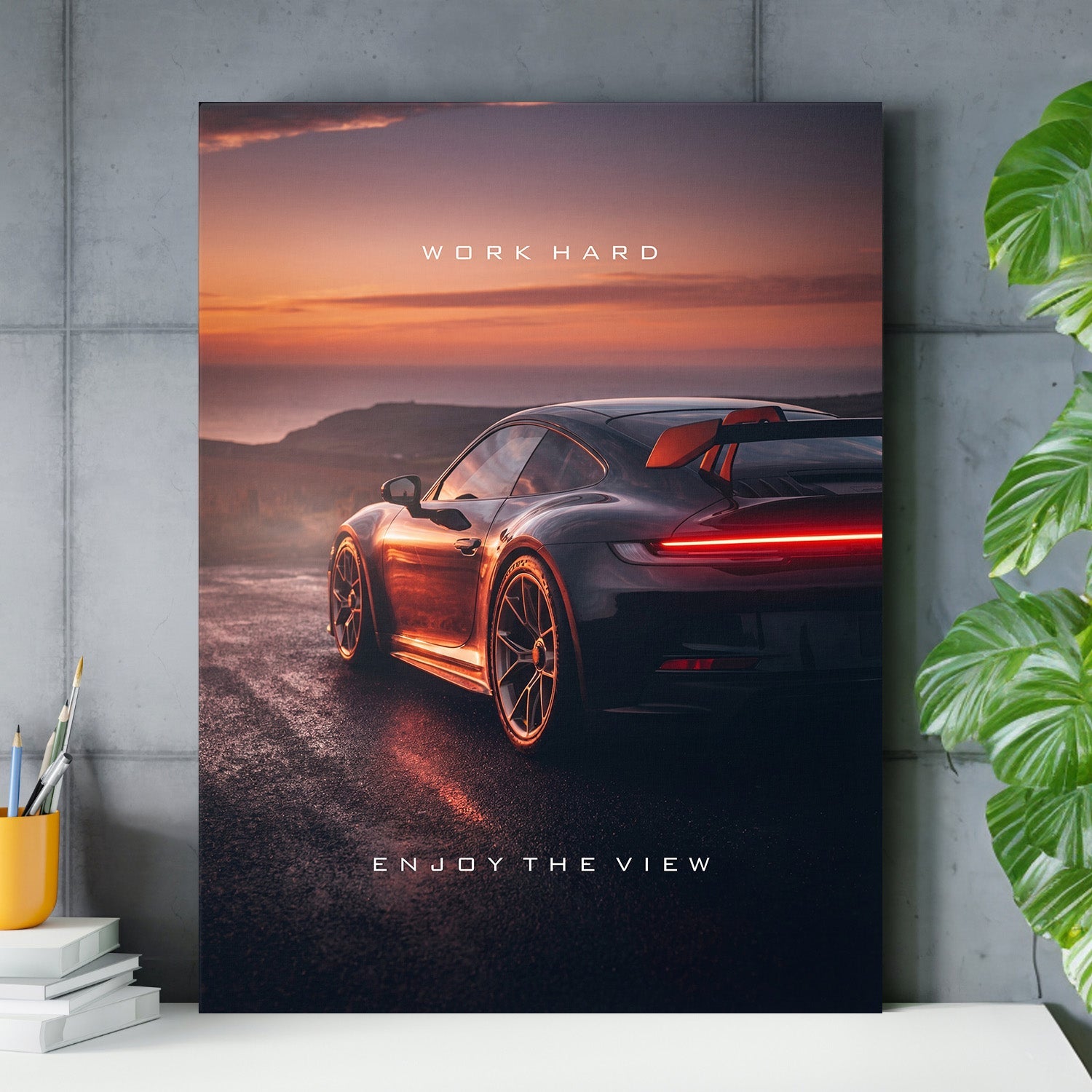 Motivational wall art with luxury sports car at sunset and minimalist quote for an office