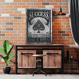 Motivational canvas wall art with a spade symbol and “Success, Work Hard, Make It Happen” quote in an industrial interior.