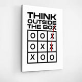 Front view of motivational canvas wall art with a minimalist tic-tac-toe pattern and “Think Outside the Box” text.