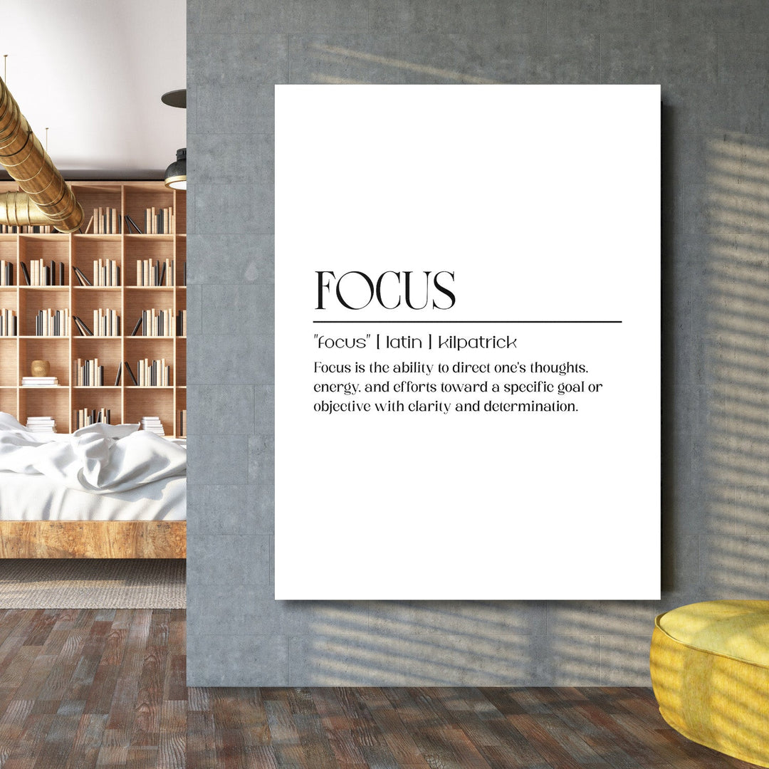 FOCUS motivational wall art with minimalist typography on a concrete wall in a modern living room beside a bookcase