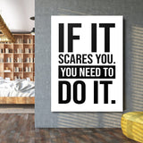 Motivational wall art with the quote “If it scares you, you need to do it” in an industrial interior