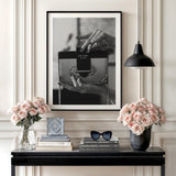 Modern wall art with a black and white photograph of hands holding a handbag in an elegant interior