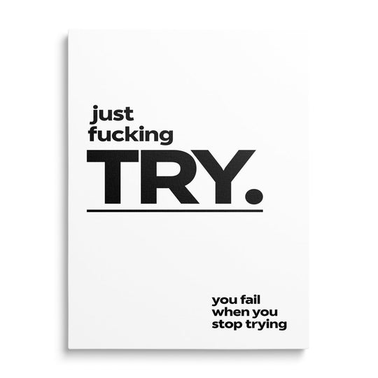 Front-view black-and-white motivational canvas print with bold “just f**king TRY” text