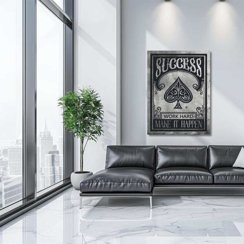 Black and white motivational wall art with “Success – Work Hard, Make It Happen” in an office with a city view.