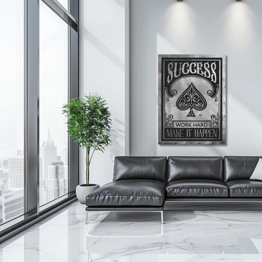 Black and white motivational wall art with “Success – Work Hard, Make It Happen” in an office with a city view.
