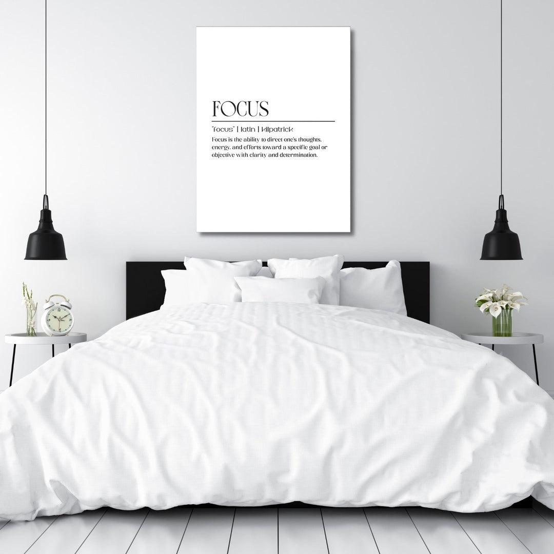 Bedroom with a black headboard and FOCUS motivational canvas wall art, styled with table lamps and flowers