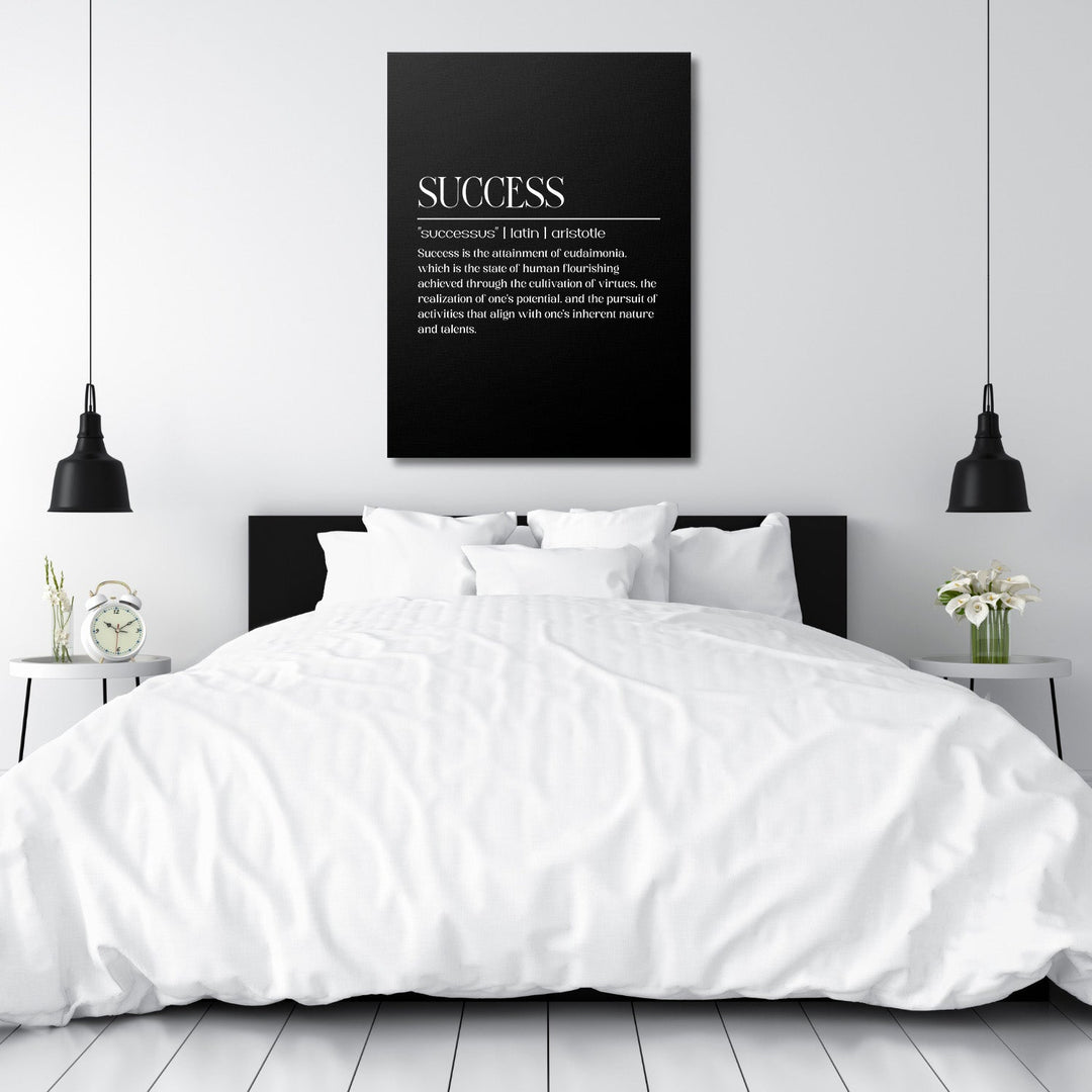 Motivational wall art with a black-and-white “Success” quote above a bed in a minimalist bedroom