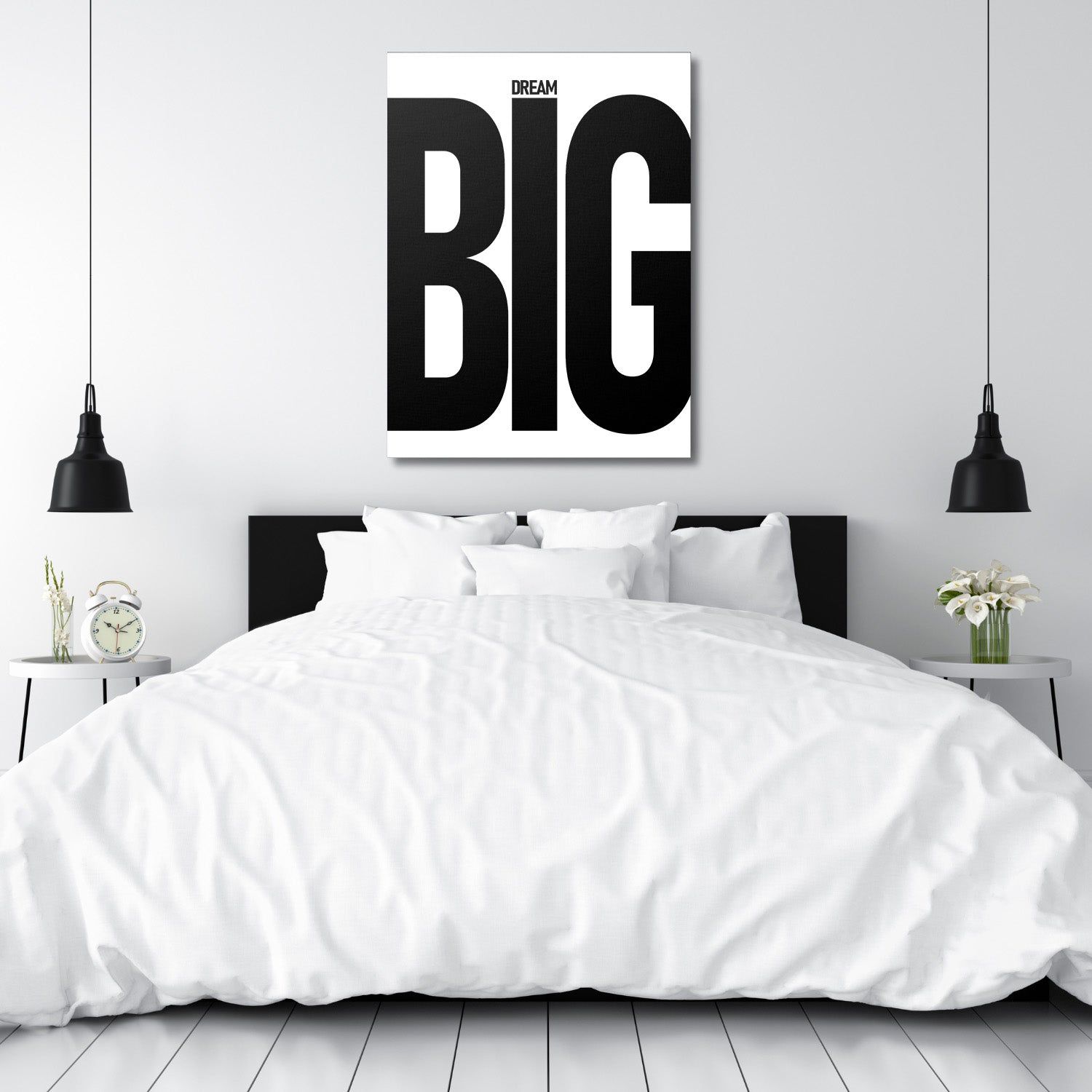 DREAM BIG black and white motivational canvas wall art above a white bed in a minimalist bedroom
