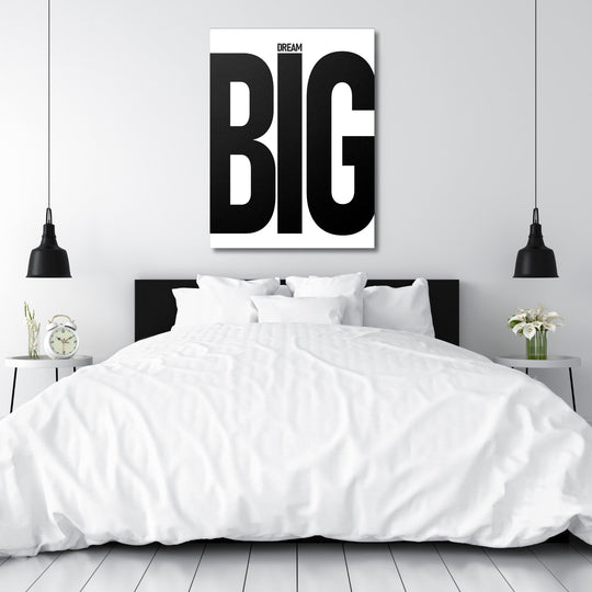 DREAM BIG black and white motivational canvas wall art above a white bed in a minimalist bedroom