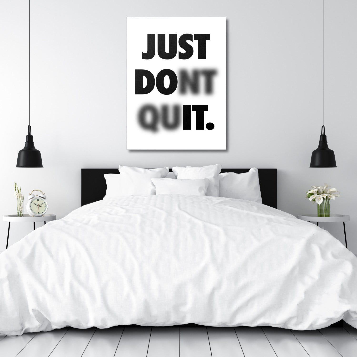 Black and white motivational quote wall art above a bed in a minimalist bedroom