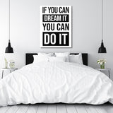 Black and white motivational quote canvas wall art above a bed in a minimalist modern bedroom