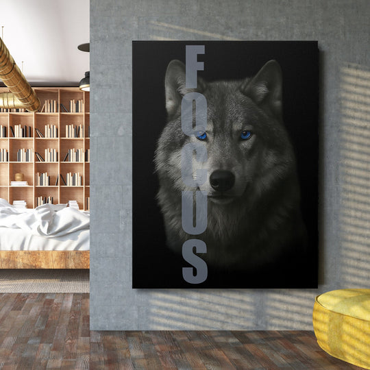 Motivational canvas wall art with a wolf and FOCUS text on a concrete wall in a modern office.