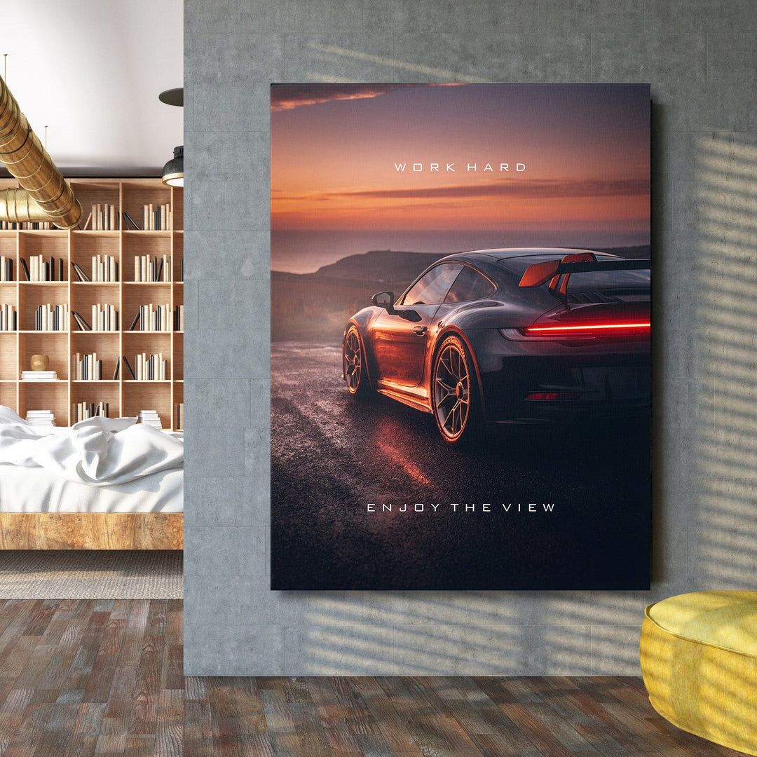 Motivational canvas wall art with sports car at sunset in a modern home office, business lifestyle