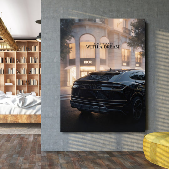 Motivational wall art with a black Lamborghini in front of a luxury store and the quote “It All Starts With a Dream” in a loft interior