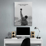 Motivational wall art above a desk with a black and white boxing stance and an inspirational quote.