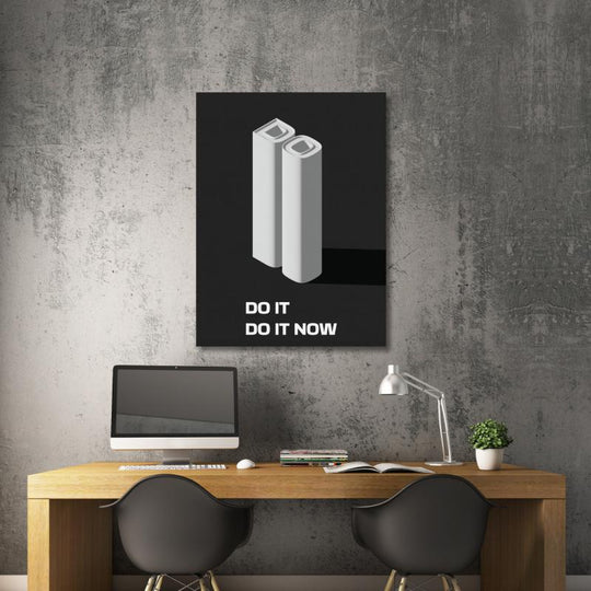 Office motivational wall art with a 3D “DO IT DO IT NOW” quote above a work desk.