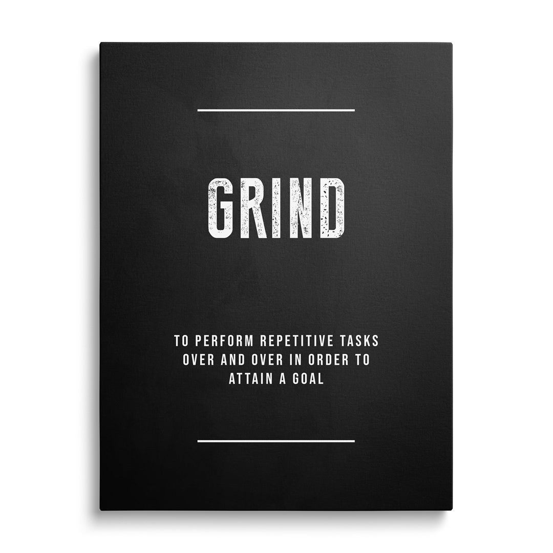 GRIND motivational canvas print on a white wall.