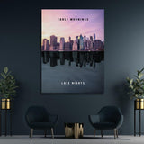 Motivational canvas wall art with a night city skyline and water reflection in a modern office.