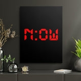 Motivational canvas print with red NOW lettering in a minimalist home office