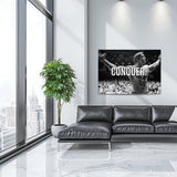 Motivational wall art with a black and white bodybuilder raising his arms and CONQUER text in a modern living room.
