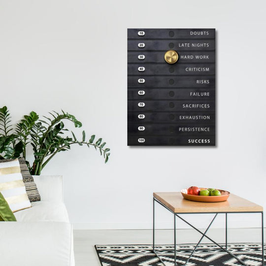 Motivational wall art with a black effort scale and gold knob set to Hard Work in a modern office.