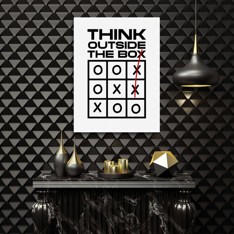 Motivational wall art in a modern office with a minimalist “Think Outside the Box” quote and tic-tac-toe motif.